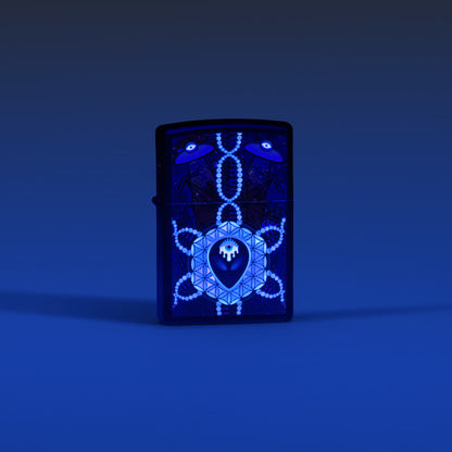Lifestyle image of Zippo All Seeing Alien Design Black Matte Windproof Lighter glowing in the dark with a blue ombre background.