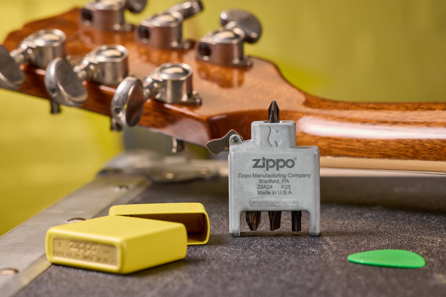 Lifestyle  Image of the Bit Safe Screwdriver USA with Sunflower case both sitting on a table with guitar.