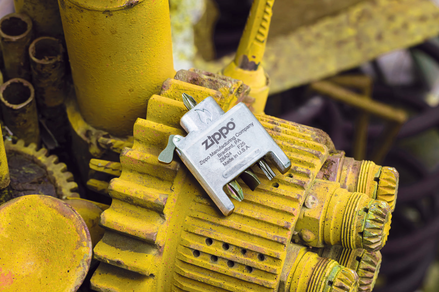 Lifestyle image of Bit Safe Screwdriver Lighter insert laying on a yellow engine.