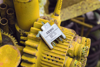 Lifestyle image of Bit Safe Screwdriver Lighter insert laying on a yellow engine.